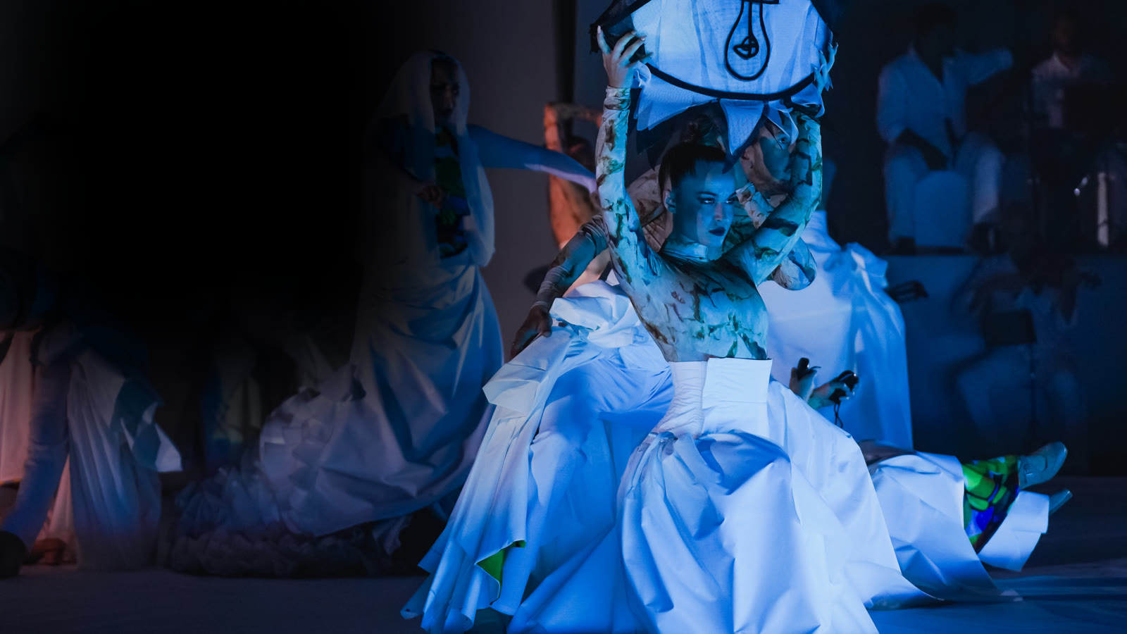 Eterno theatrical performance under blue stage lighting
