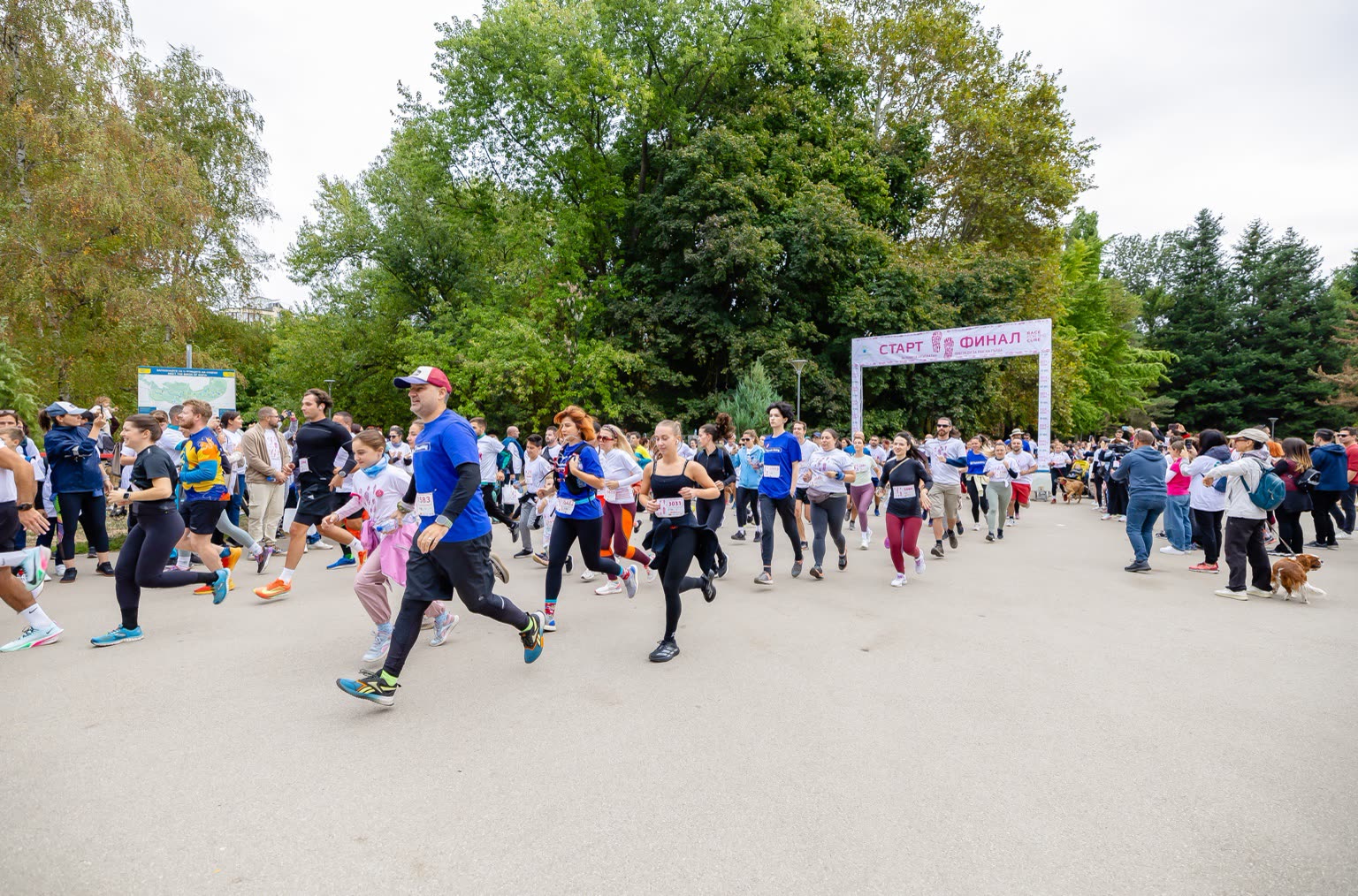 Crowd of participants gathering at the Race for the Cure Bulgaria start and finish arch in Sofia